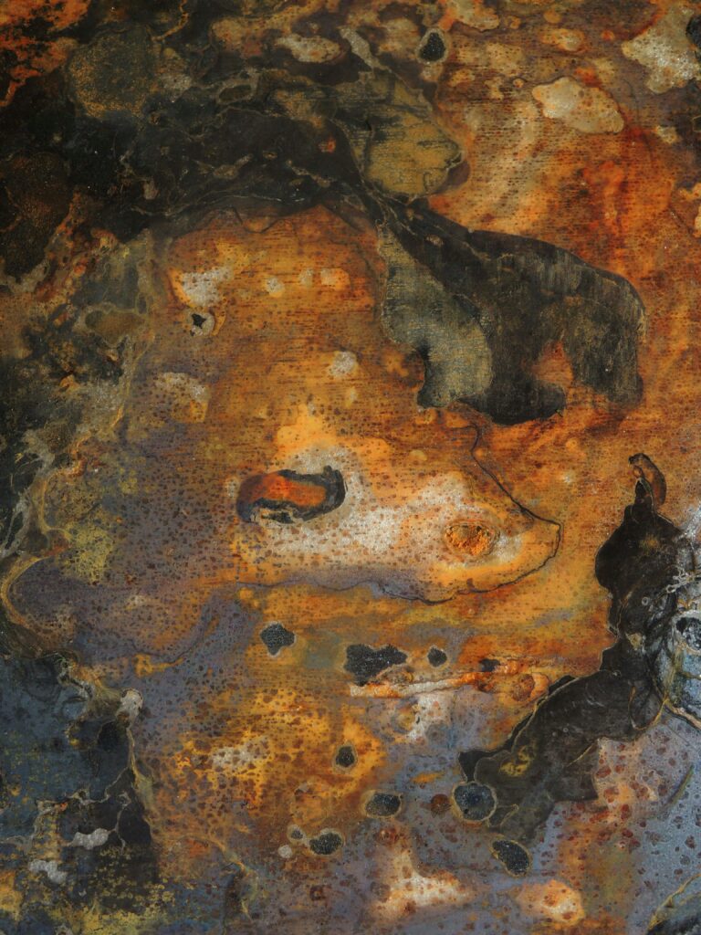 Close-up of rusty metal surface with unique abstract patterns and colors